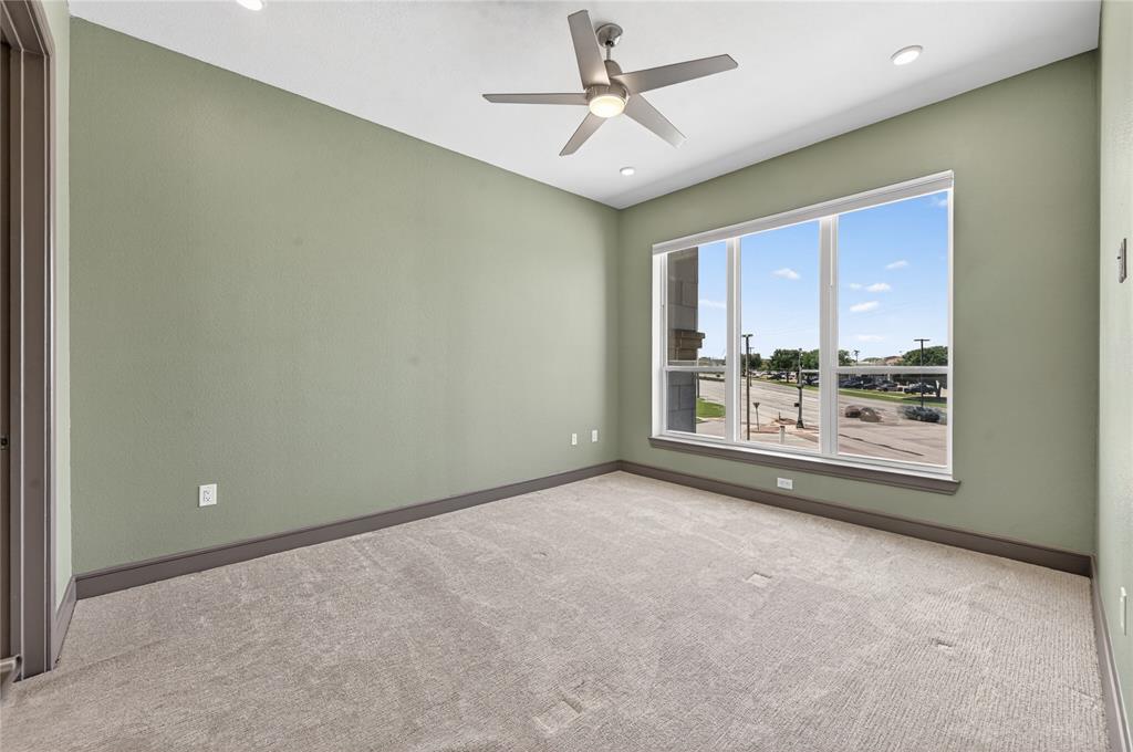 2700 Old Denton Road, Unit 2259 Carrollton, TX 75007 - Photo 19 of 39 a view of a big room with windows and chandelier fan