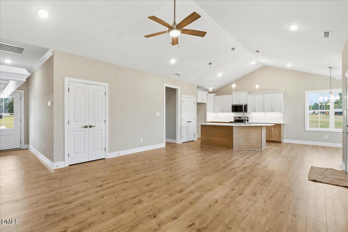 1345 Scarlet Oak Rd Spring Spring Hope, NC 27882 - Photo 6 of 23 a view of an empty room and kitchen view with wooden floor