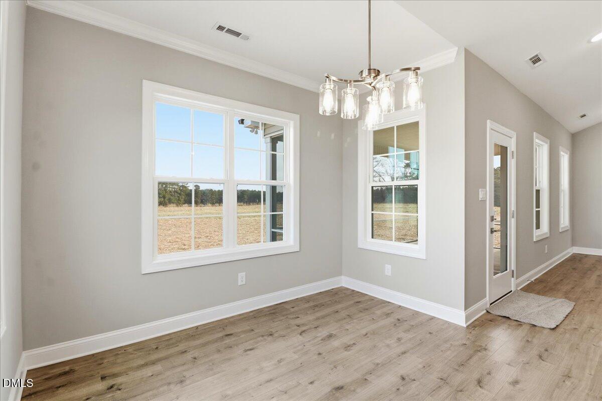 1345 Scarlet Oak Rd Spring Spring Hope, NC 27882 - Photo 10 of 23 an empty room with wooden floor and windows