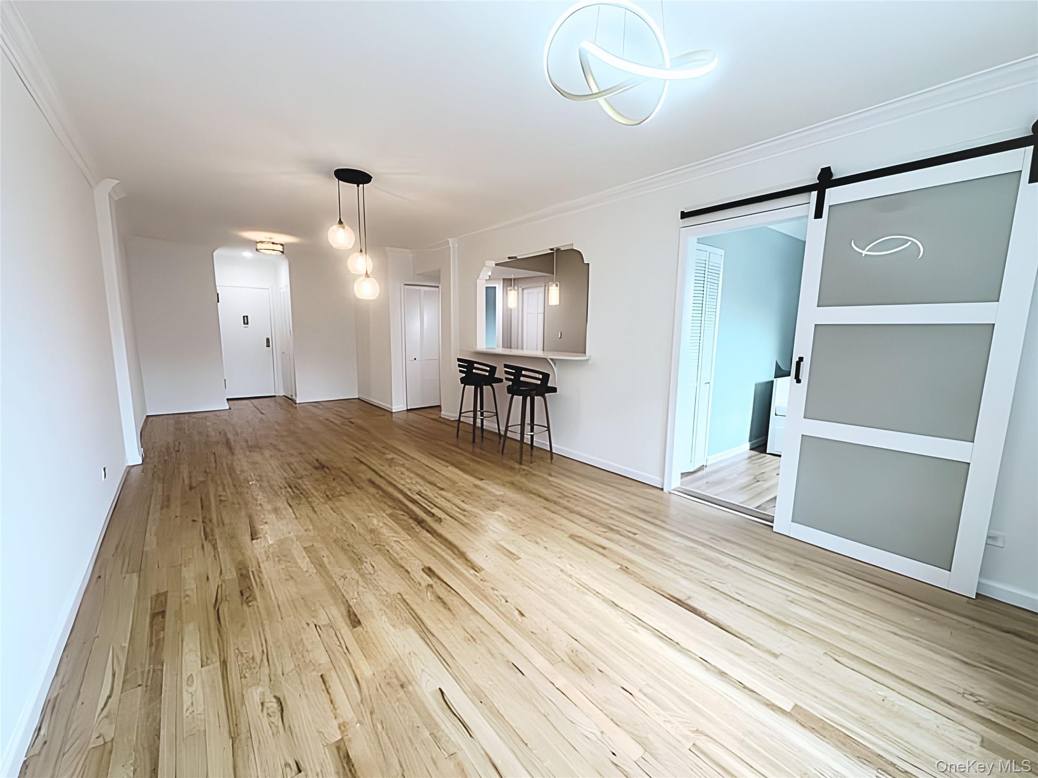800 Grand Concourse, Unit 2JS Bronx, NY 10451 - Photo 4 of 18 a view of a livingroom with furniture and wooden floor