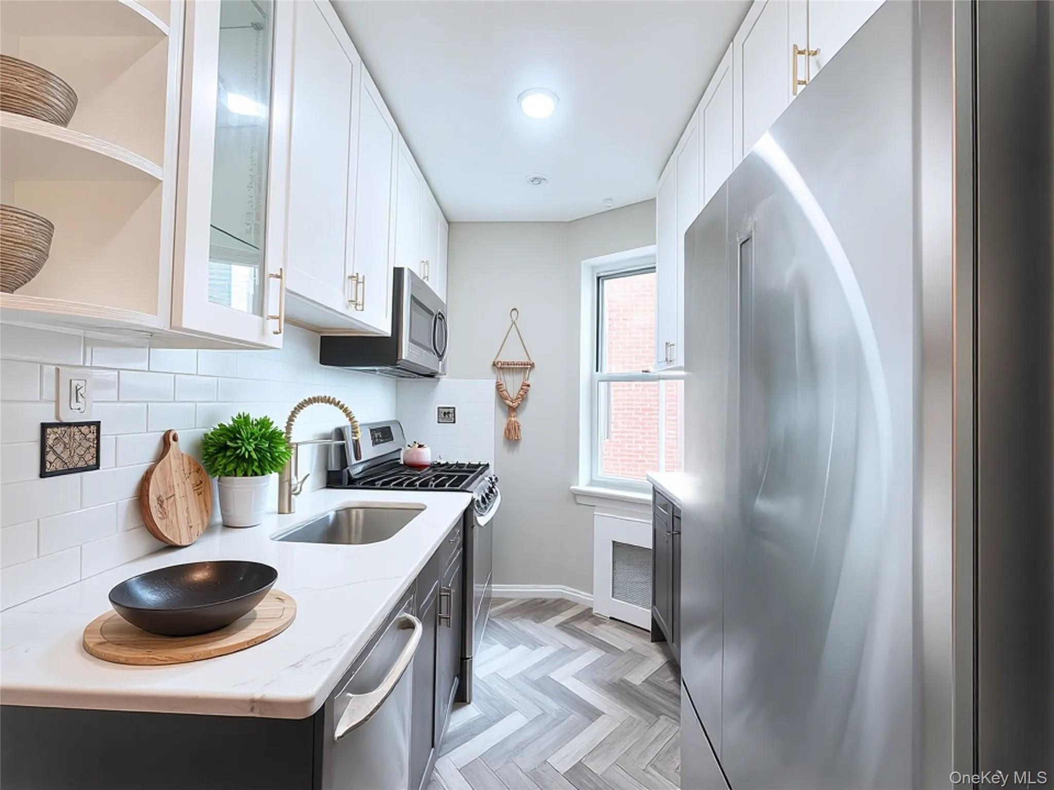 800 Grand Concourse, Unit 2JS Bronx, NY 10451 - Photo 5 of 18 a kitchen with stainless steel appliances a sink a refrigerator and a stove