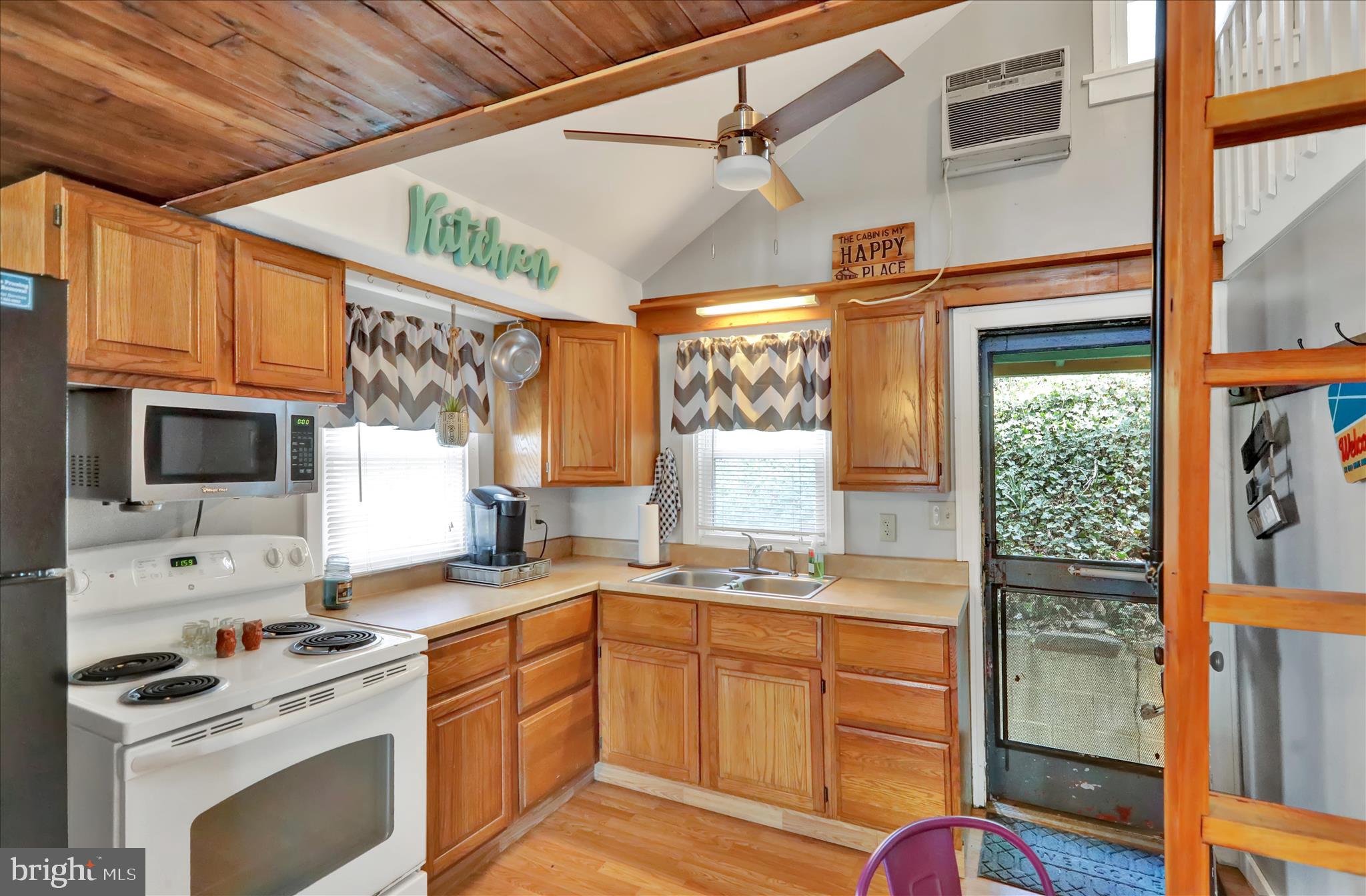 408 Circle Lane Peach Bottom, PA 17563 - Photo 8 of 27 a kitchen with granite countertop a stove a sink and a refrigerator