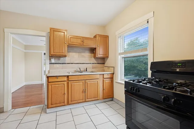 a kitchen with stainless steel appliances granite countertop a stove a sink and a microwave