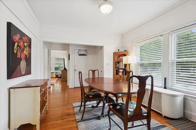 a view of a dining room with furniture window and wooden floor