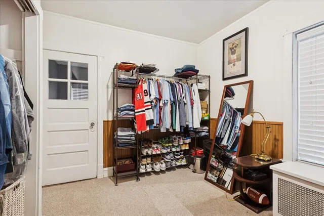 a view of walk in closet with clothes