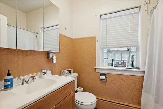 a bathroom with a sink a toilet and mirror