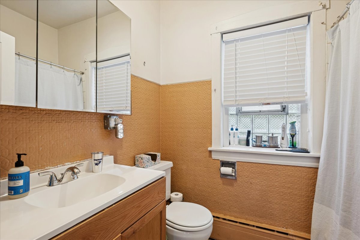 600 Ferdinand Avenue Forest Park, IL 60130 - Photo 8 of 20 a bathroom with a sink a toilet and mirror