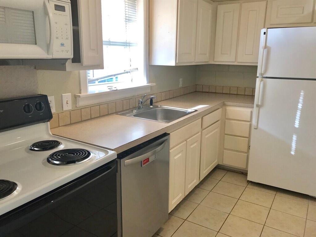 210 Austin Street Grapevine, TX 76051 - Photo 5 of 9 a kitchen with a sink cabinets and appliances