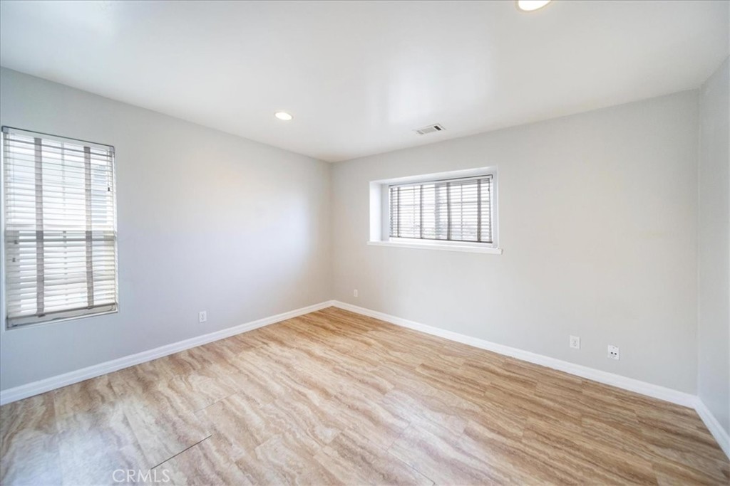 570 Emory Street Imperial Beach, CA 91932 - Photo 18 of 43 an empty room with wooden floor and windows