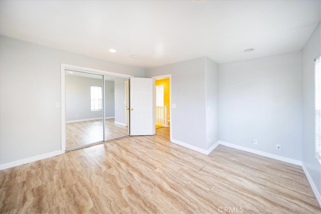 570 Emory Street Imperial Beach, CA 91932 - Photo 19 of 43 a view of an empty room with wooden floor and a window