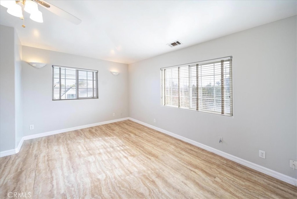 570 Emory Street Imperial Beach, CA 91932 - Photo 20 of 43 a view of an empty room with wooden floor and a window