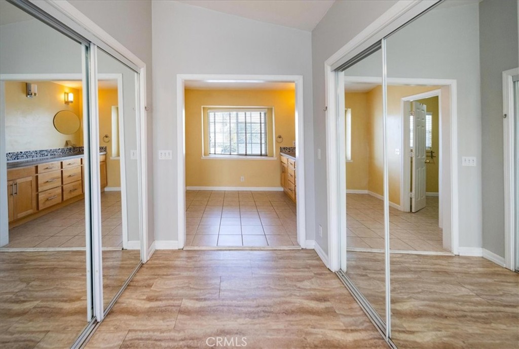 570 Emory Street Imperial Beach, CA 91932 - Photo 24 of 43 a view of a hallway with wooden floor and a bathroom