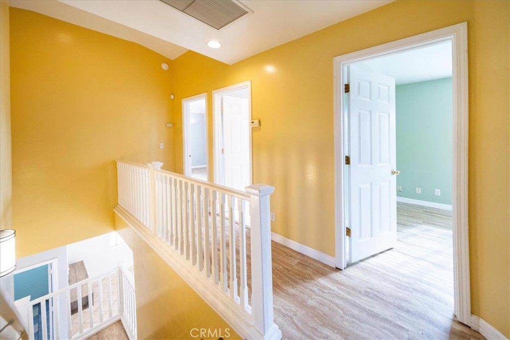 570 Emory Street Imperial Beach, CA 91932 - Photo 32 of 43 a view of a hallway with wooden floor and a bathroom