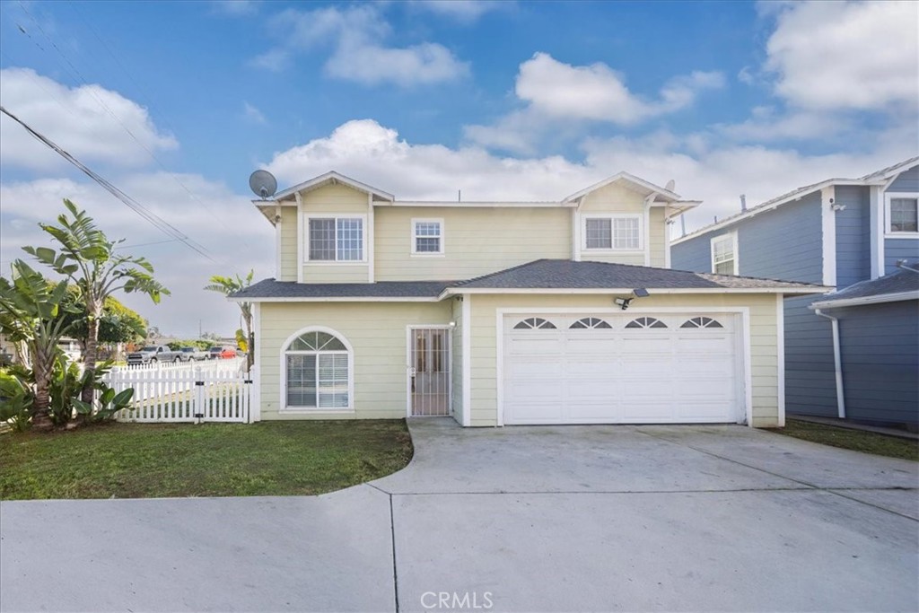 570 Emory Street Imperial Beach, CA 91932 - Photo 4 of 43 a view of a white house with a yard and garage