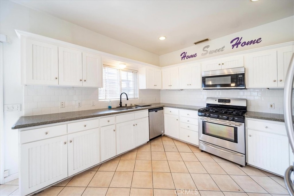 570 Emory Street Imperial Beach, CA 91932 - Photo 10 of 43 a kitchen with cabinets appliances and a window