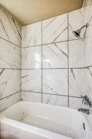 en empty room with a ceiling fan and a window