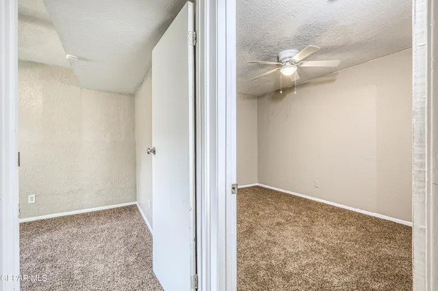 a view of a livingroom with a furniture ceiling fan and window