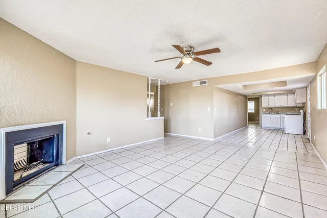 a kitchen with white cabinets and appliances