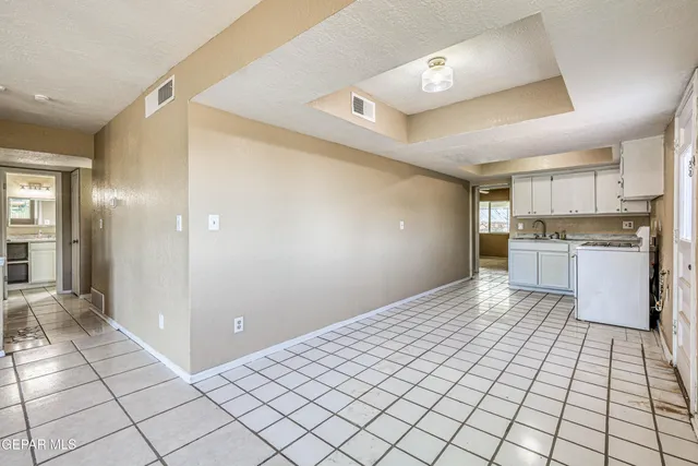 a kitchen with granite countertop white cabinets and sink
