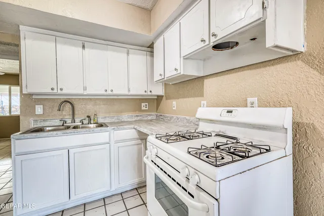 an empty room with a ceiling fan and a window