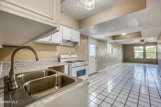 an empty room with a ceiling fan and a window