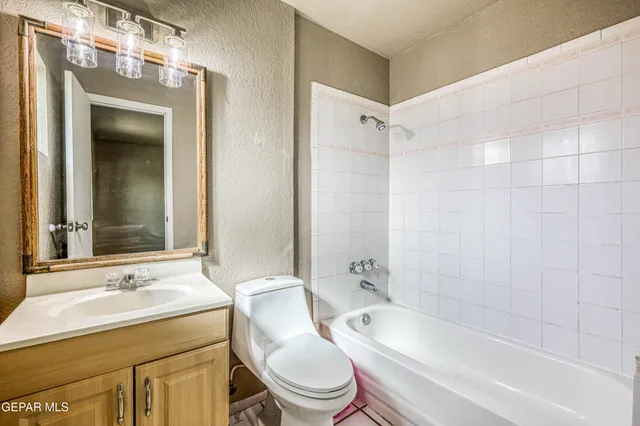 a view of a room with wooden floor and iron stairs