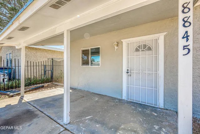 a view of a porch with a table and chairs