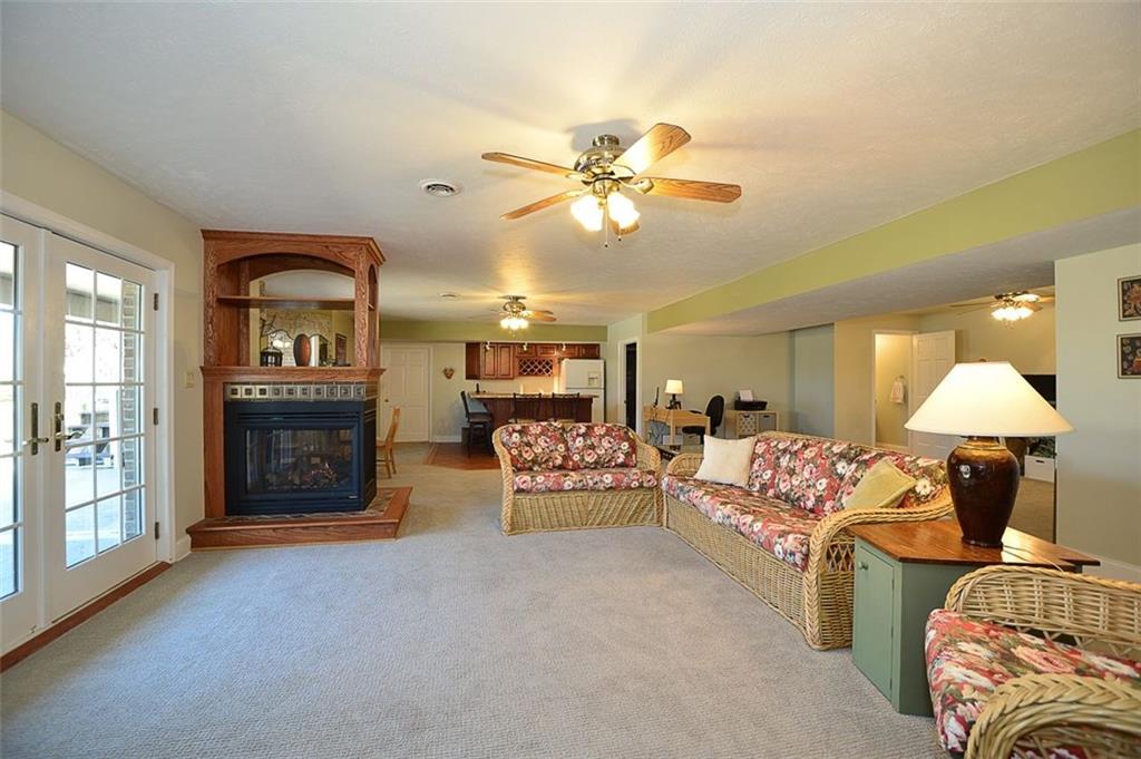 108 Cloverleaf Lane Butler, PA 16001 - Photo 22 of 25 LOWER LEVEL Family Room is a GREAT BIG EXPANSION SPACE & Entertainment Central. WALK-OUT ACCESS to a MASSIVE lower concrete patio BBQ area complete with concrete serving island w/ chairs. New carpet, new wall paint, custom gas fireplace and access to the single car garage too. Lots & lots of storage space.