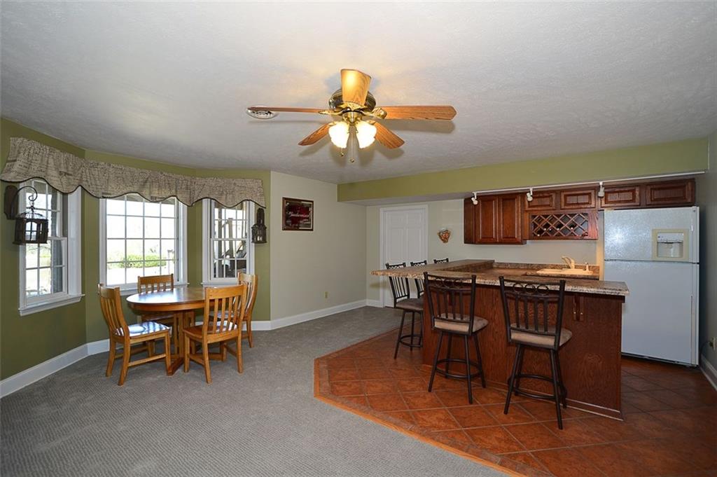 108 Cloverleaf Lane Butler, PA 16001 - Photo 23 of 25 LOWER LEVEL Kitchenette/ Full Bar area complete with eat-in bump out area that overlooks the outdoor patio & sprawling back lawns. New carpeting throughout the lower level.