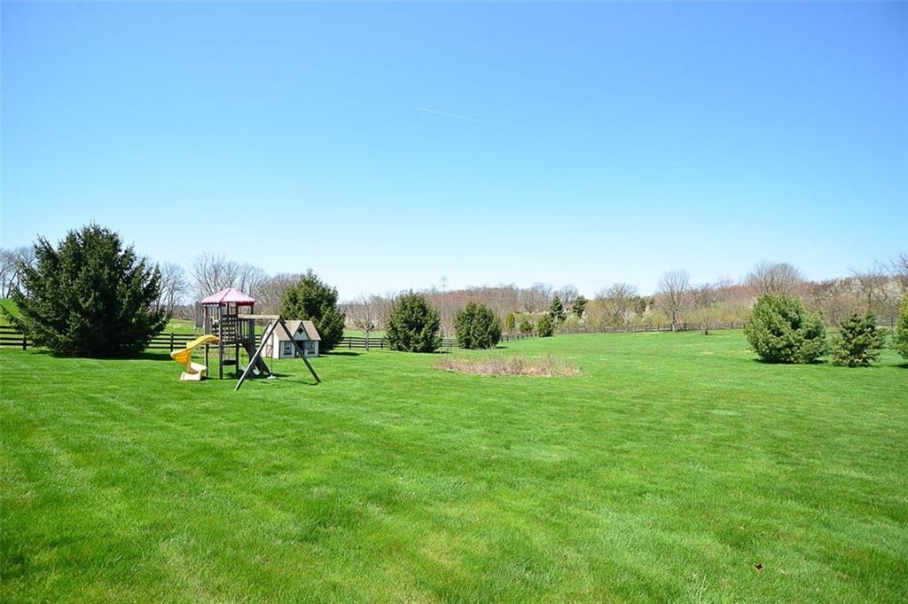 108 Cloverleaf Lane Butler, PA 16001 - Photo 6 of 25 This is a side yard view which includes a small children's playset and storage shed which is used to store the outdoor deck & patio furniture.