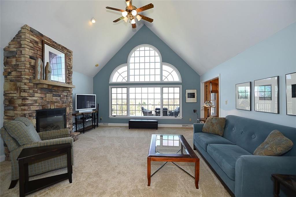 108 Cloverleaf Lane Butler, PA 16001 - Photo 10 of 25 Main floor VAULTED Living Room flows from the Entryway and Kitchen areas. LARGE, LARGE beautiful window work captures the fullness of the outdoor lawns & elevated deck. Gas fireplace w/ custom stonework! New paint & carpet.