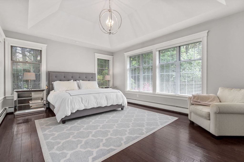 358 Cartwright Road Needham, MA 02492 - Photo 18 of 35 a bedroom with a bed and wooden floor