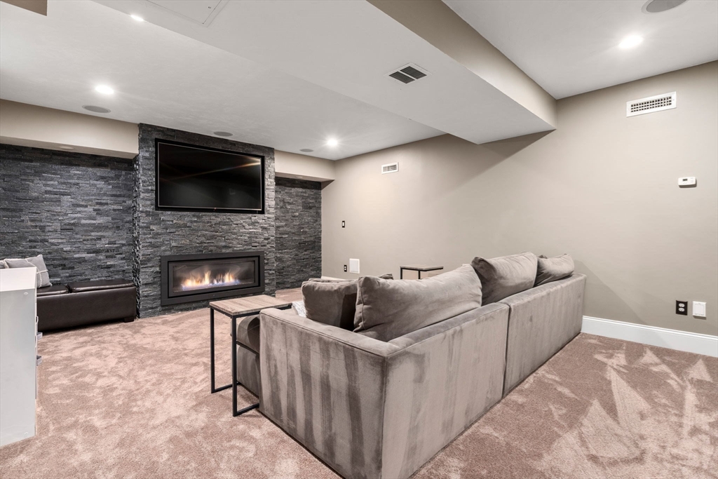 358 Cartwright Road Needham, MA 02492 - Photo 29 of 35 a living room with furniture and a fireplace