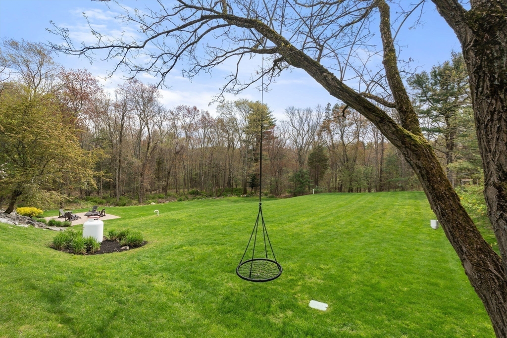 358 Cartwright Road Needham, MA 02492 - Photo 32 of 35 a backyard of a house with lots of green space