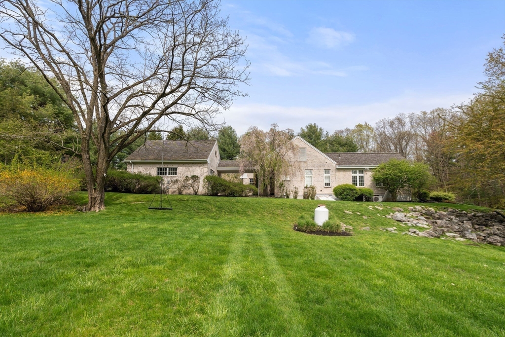 358 Cartwright Road Needham, MA 02492 - Photo 33 of 35 a view of a house with a big yard and large trees