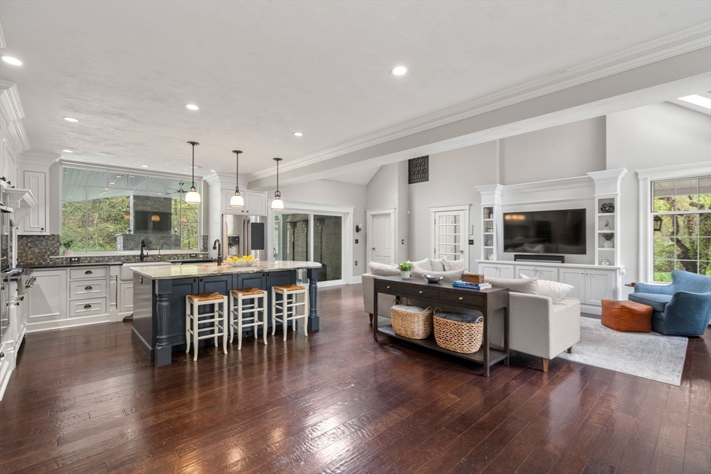 358 Cartwright Road Needham, MA 02492 - Photo 6 of 35 a living room with furniture a flat screen tv and floor to ceiling window