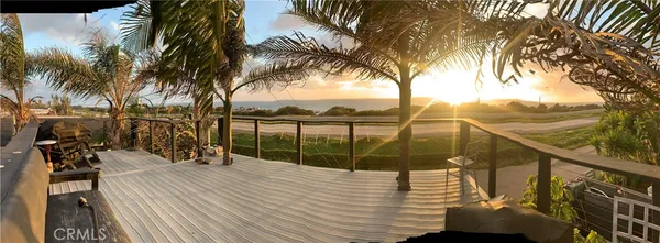 a view of a balcony with lake view and a palm tree