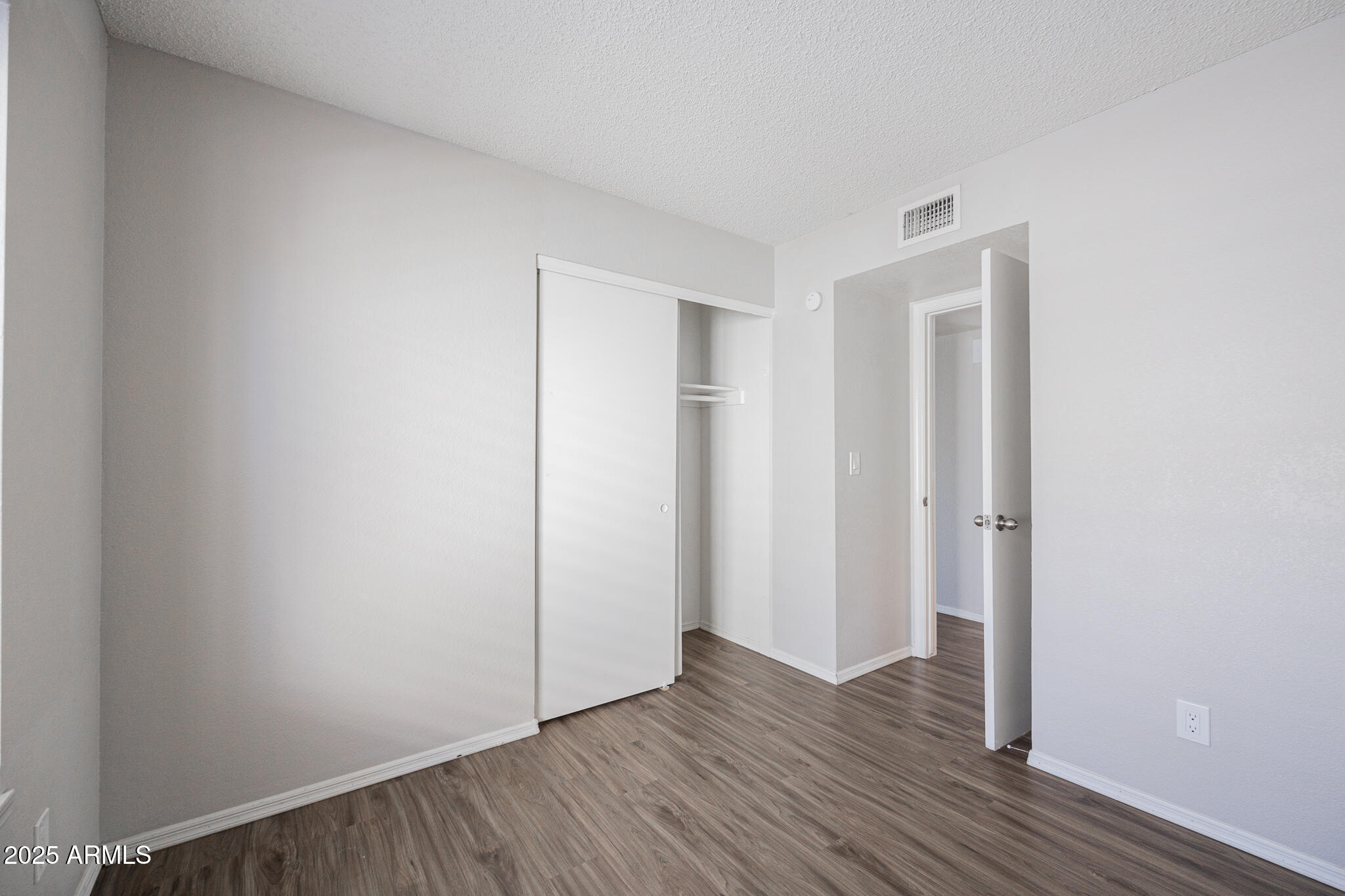 619 East Jensen Street, Unit 42 Mesa, AZ 85203 - Photo 20 of 24 a view of an empty room with wooden floor