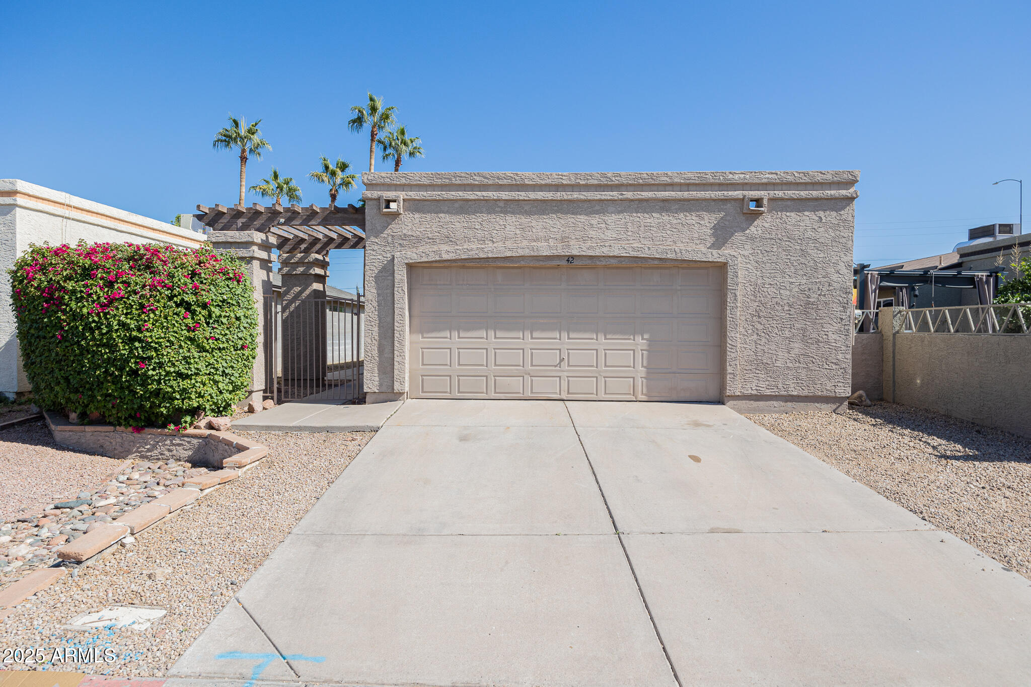 619 East Jensen Street, Unit 42 Mesa, AZ 85203 - Photo 2 of 24 a front view of a house with a garage