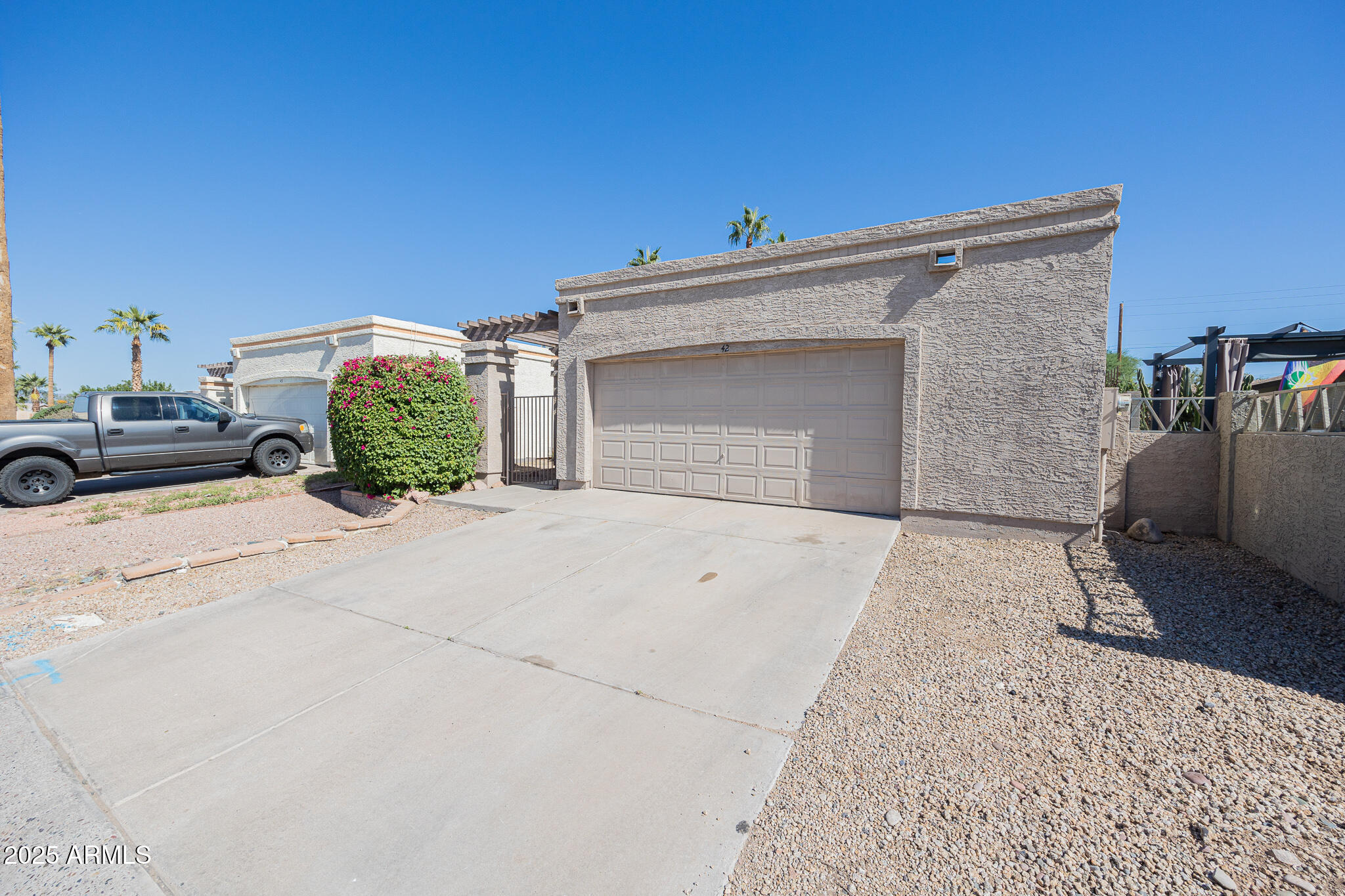 619 East Jensen Street, Unit 42 Mesa, AZ 85203 - Photo 3 of 24 a front view of a house with a yard
