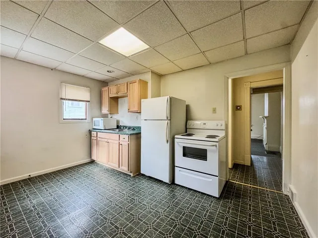 a kitchen with granite countertop white cabinets and stainless steel appliances