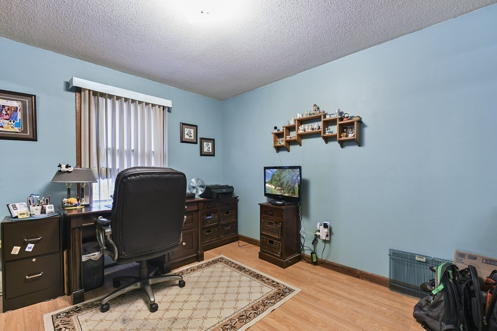 279 Little Alum Road Brimfield, MA 01010 - Photo 14 of 37 a view of a workspace with furniture and a window