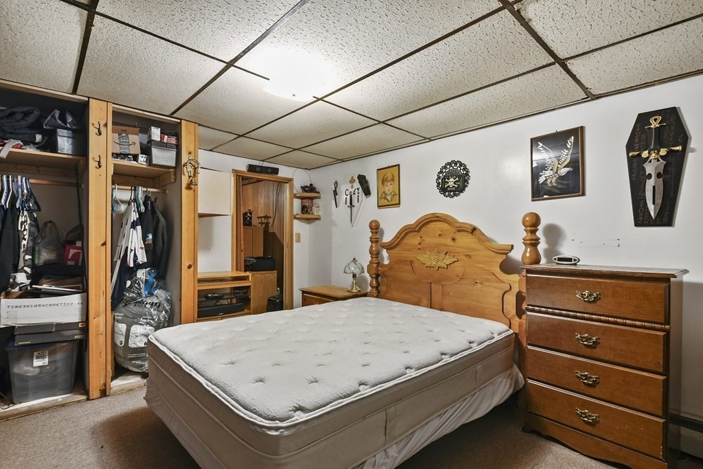 279 Little Alum Road Brimfield, MA 01010 - Photo 19 of 37 a bedroom with a bed and a flat tv screen on the dresser