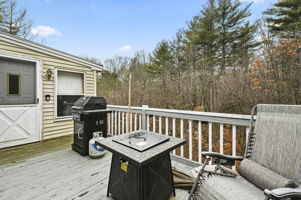 279 Little Alum Road Brimfield, MA 01010 - Photo 32 of 37 a view of a deck with wooden floor and furniture