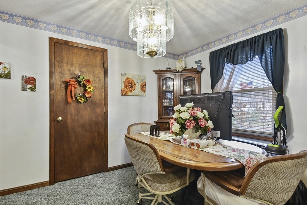 279 Little Alum Road Brimfield, MA 01010 - Photo 6 of 37 a view of a dining room with furniture and chandelier