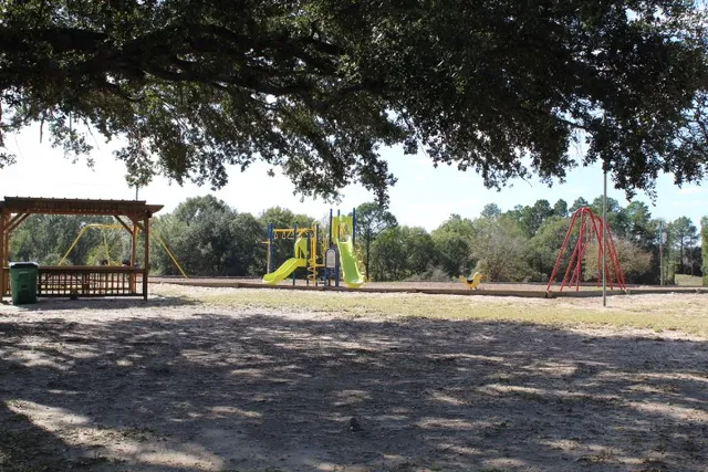 a view of outdoor space with playground and green space