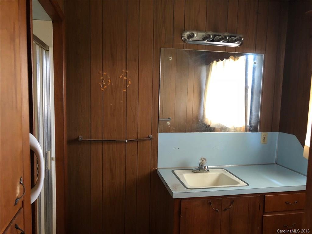320 Weaver Road Salisbury, NC 28147 - Photo 8 of 10 a bathroom with a sink a mirror and window