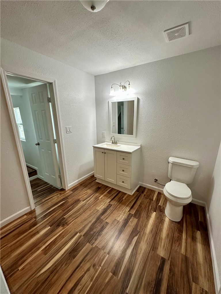 323 Copano Bayside, TX 78340 - Photo 11 of 22 a spacious bathroom with a toilet a sink and a mirror