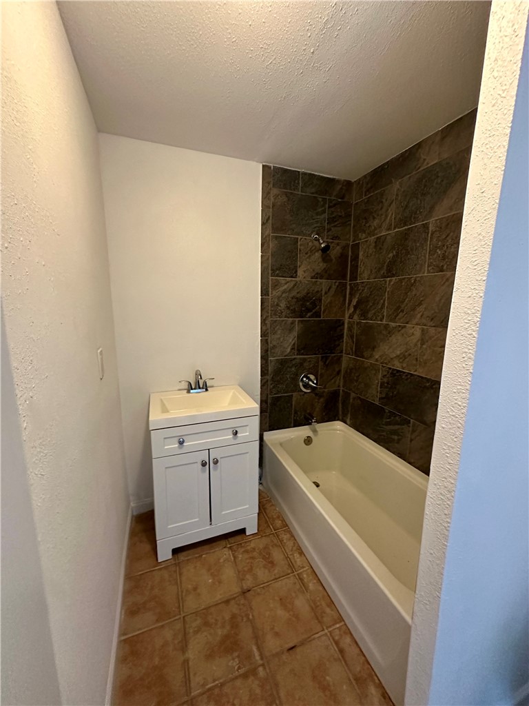 323 Copano Bayside, TX 78340 - Photo 9 of 22 a bathroom with a bathtub a sink a toilet and a shower