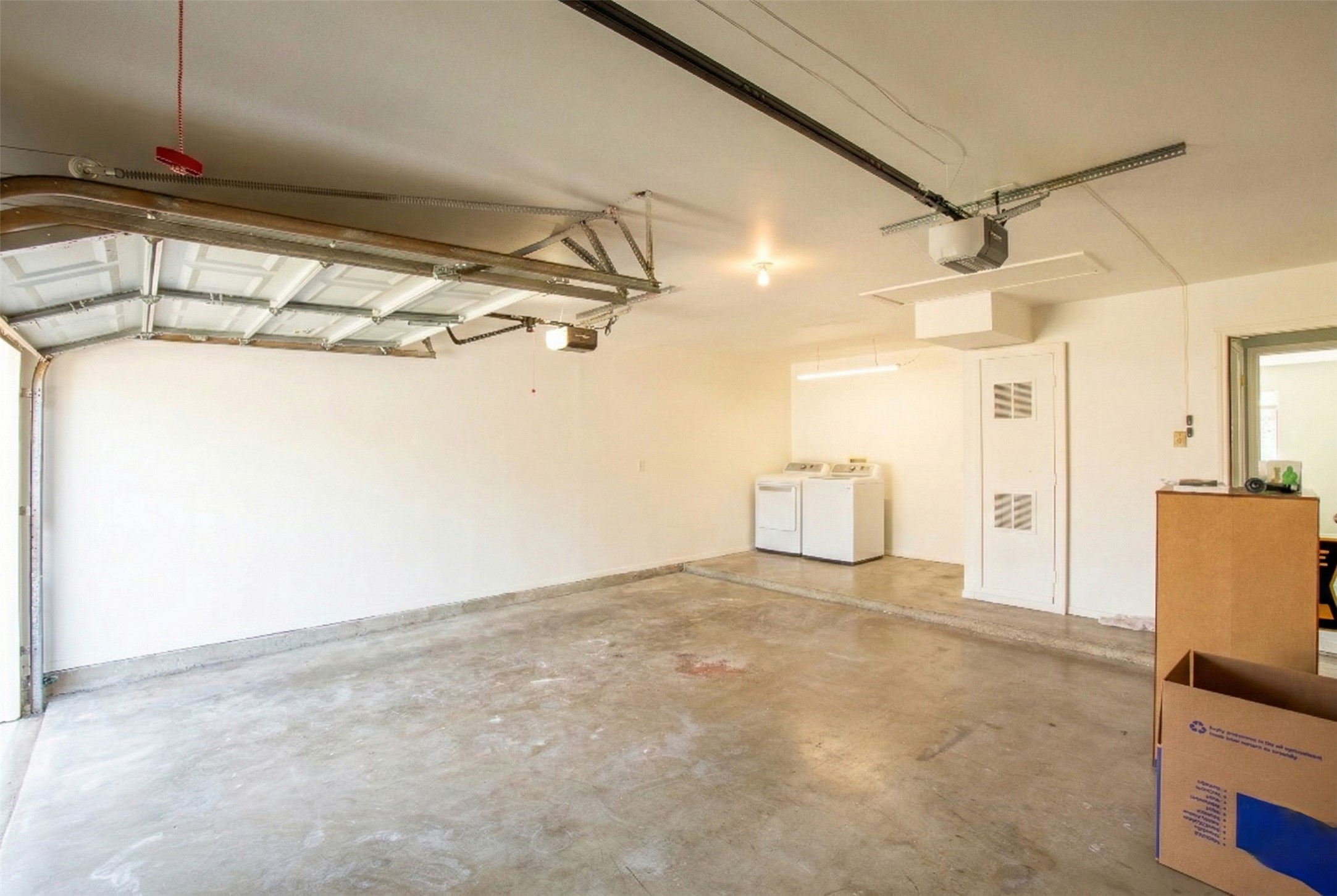 8007 Swindon Lane Austin, TX 78745 - Photo 26 of 27 Garage featuring washing machine and dryer and a garage door opener